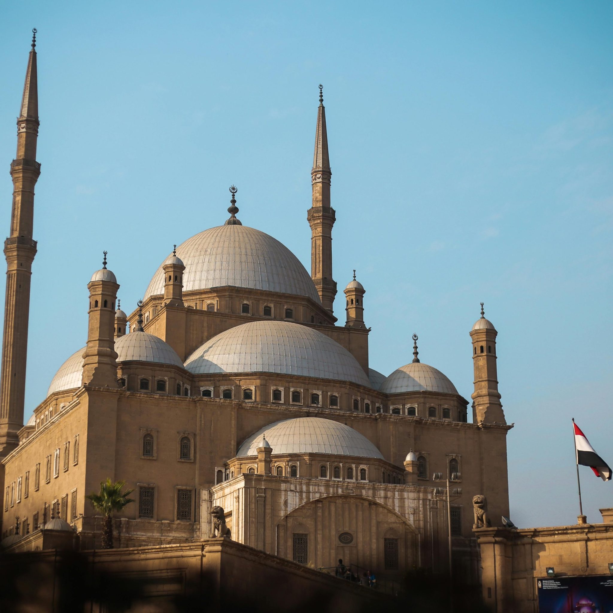 Explore the architectural beauty of the historic mosque in Cairo, featuring majestic domes and minarets.