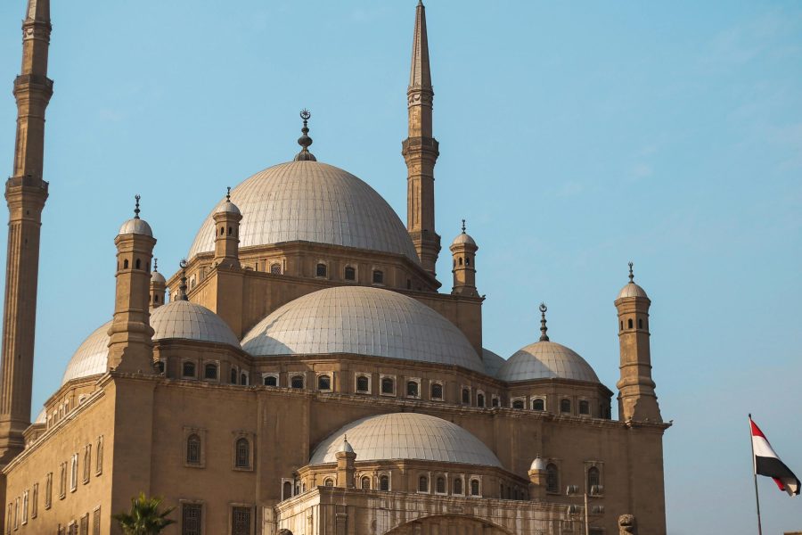 Explore the architectural beauty of the historic mosque in Cairo, featuring majestic domes and minarets.