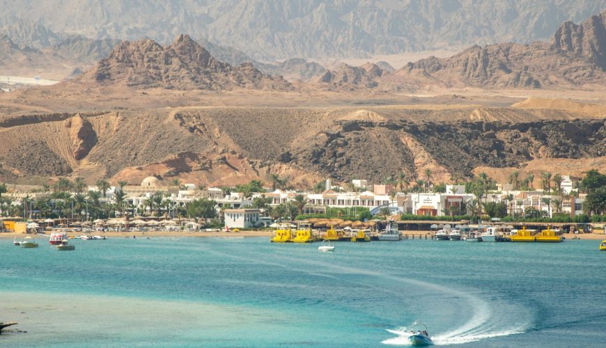 A stunning seaside town with turquoise waters and rugged mountains.