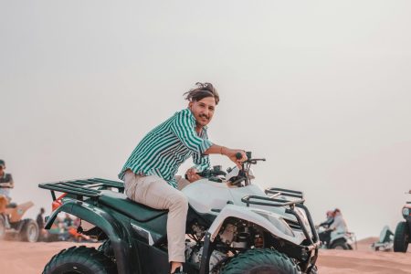 Group riding quads in a vast desert landscape, exuding adventure and excitement.