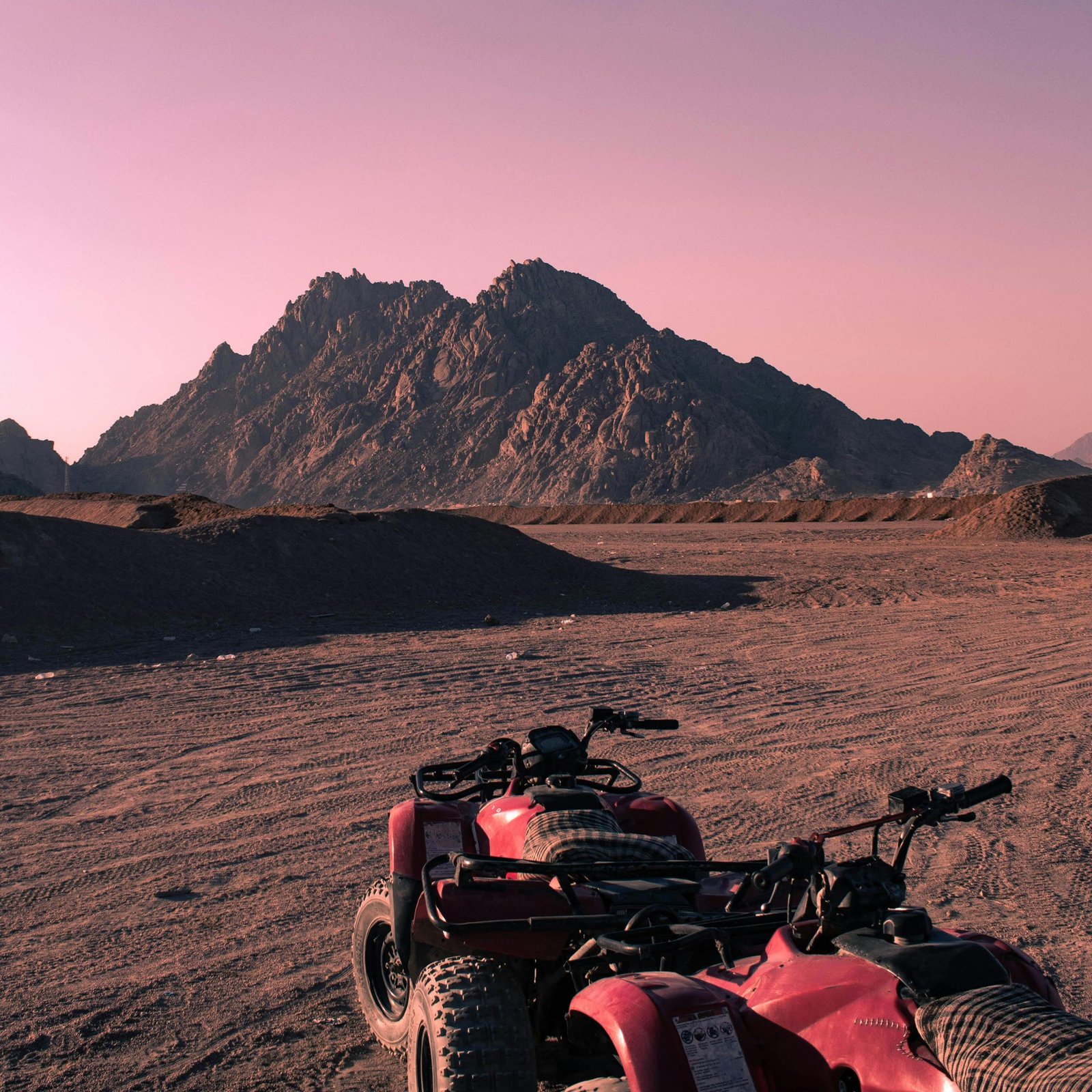 Quad bikes on a desert landscape in Sharm El-Sheikh, Egypt at sunset.