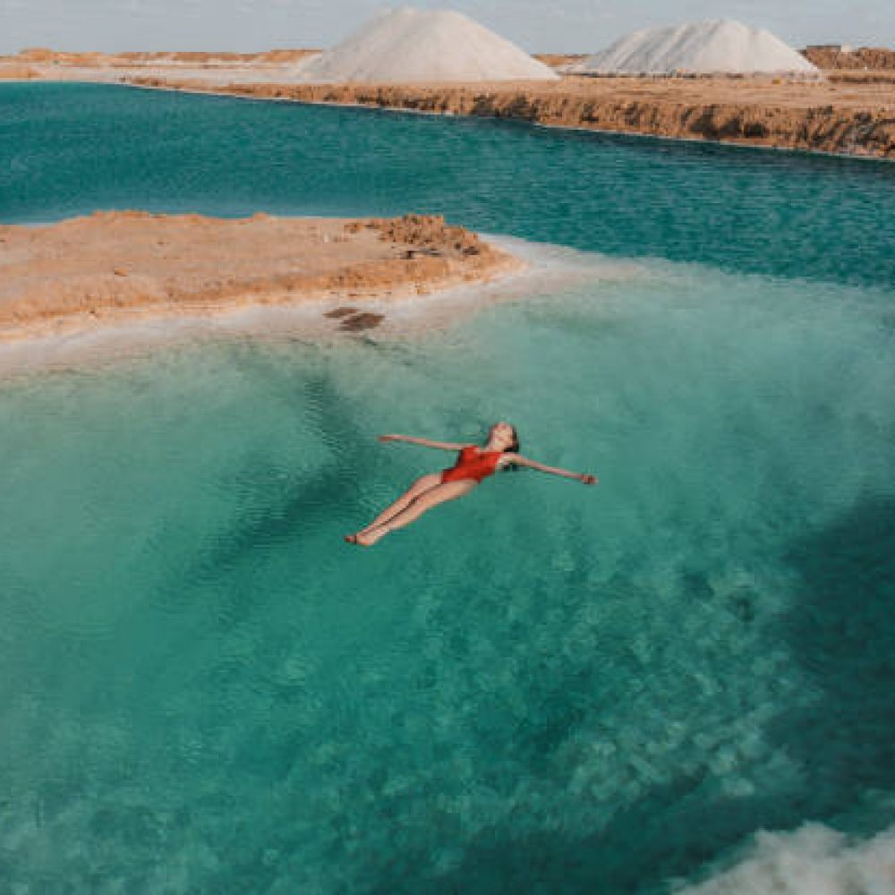 Young Caucasian woman swimming in salt lake in Siwa oasis